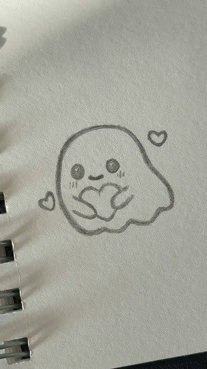 Fantasminha fofo segurando um coração para desenhar no tédio
