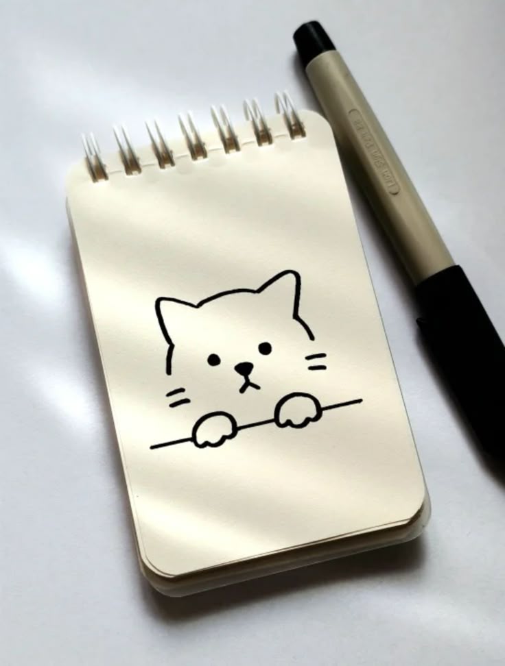 Desenho de um gato fofo em um bloco de notas
